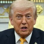 Former President Donald Trump speaking, with Federal Reserve Chair Jerome Powell in the background, symbolizing the ongoing conflict.