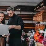 A person contemplating funeral arrangements, with a somber expression, symbolizing the emotional and financial weight of end-of-life planning.