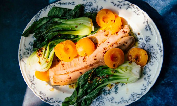 Elevate Your Plate: Ginger Salmon with Poached Apricots & Anti-Inflammatory Spices 11 Ginger-spiced salmon fillet served with bok choy and ginger-poached apricots, drizzled with chili oil.