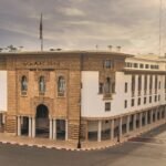 A globe surrounded by graphs and charts, symbolizing global economic uncertainty amidst geopolitical tensions.
