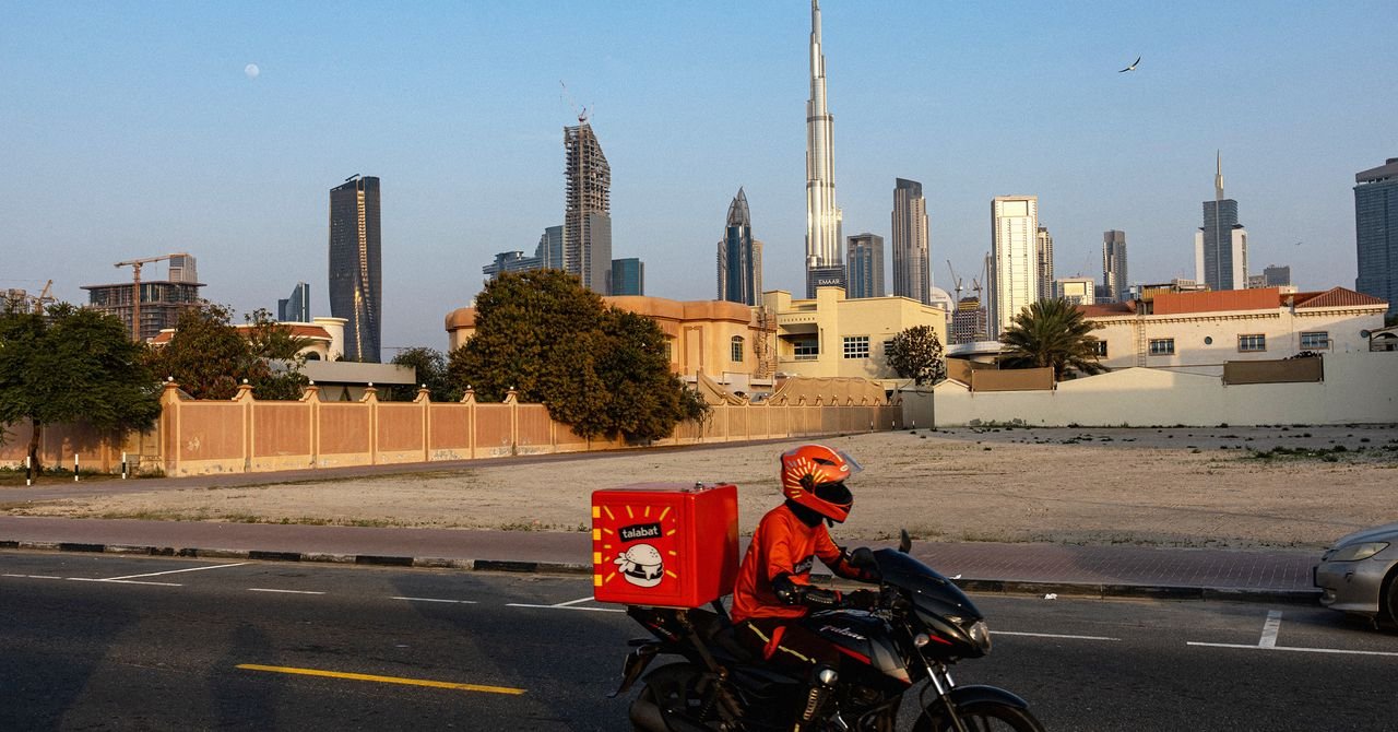 Defying Danger: The Unseen Resilience of Gulf Delivery Drivers Amidst Missile Threats 3 A delivery driver on a motorbike in the Gulf region, continuing their work amidst challenging circumstances.