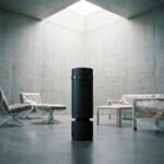 Warm Your Home, Earn Crypto: Heatbit's Innovative Approach to Smart Living 4 A Heatbit Maxi Pro smart heater, a sleek conical device that mines Bitcoin and purifies air, in a modern living space.