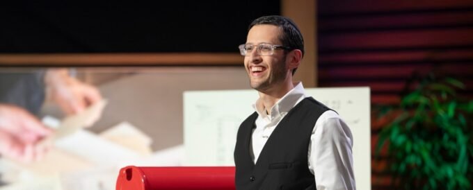 Ari Siegel, founder of History By Mail, holding historical document replicas