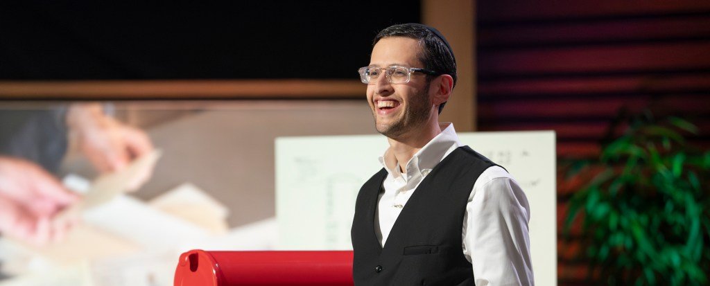 Ari Siegel, founder of History By Mail, holding historical document replicas
