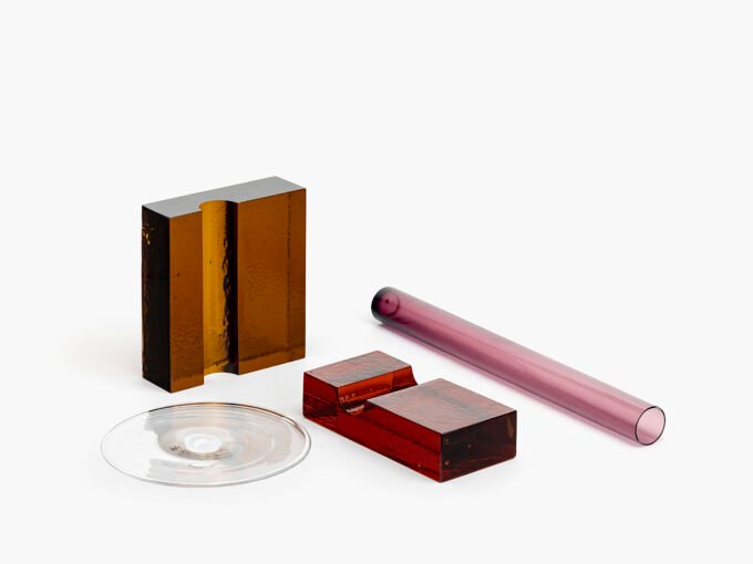 A composition from the Inchiostri exhibition, featuring layered colored glass blocks and tubes by Ronan Bouroullec and Giorgio Mastinu.