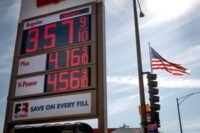 A gas pump displaying rising fuel prices with a backdrop of geopolitical tension, symbolizing the economic impact of the Iran war.