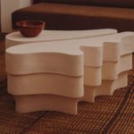 Jan Ernst's Cavus Collection: Where Karoo Landscapes Meet Contemporary Design 6 A multi-layered, ridged clay table from Jan Ernst's Cavus Collection, showcasing organic, desert-inspired forms.