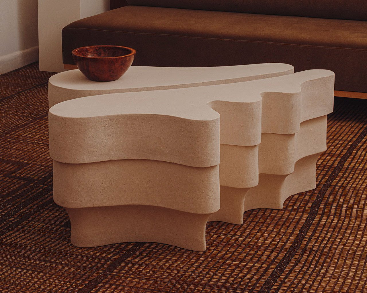 Jan Ernst's Cavus Collection: Where Karoo Landscapes Meet Contemporary Design 3 A multi-layered, ridged clay table from Jan Ernst's Cavus Collection, showcasing organic, desert-inspired forms.