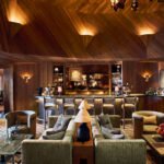Alpine Brutalism Reimagined: Kelly Wearstler's Vision at L’Apogée Courchevel 6 Interior view of L’Apogée Courchevel dining space, showcasing Kelly Wearstler's Alpine Brutalism design with textured wood and stone elements.