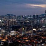 South Korean Kospi stock market chart showing a sharp decline, juxtaposed with a rising cryptocurrency chart, illustrating the market rotation.