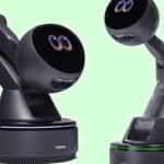 Lenovo AI Workmate Concept: A robotic arm with a screen displaying expressive eyes, designed for desktop productivity.