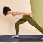 A person demonstrating a lunge with chest lift, hinging forward with a neutral spine to engage the core.