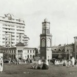 Horloge murale indiquant l'heure d'été au Maroc, avec des silhouettes de personnes en arrière-plan, symbolisant l'impact sur la vie quotidienne.