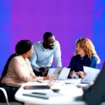 A diverse group of professionals collaborating, symbolizing adaptable skills and cross-domain knowledge sharing in a modern business environment.