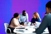 A diverse group of professionals collaborating, symbolizing adaptable skills and cross-domain knowledge sharing in a modern business environment.