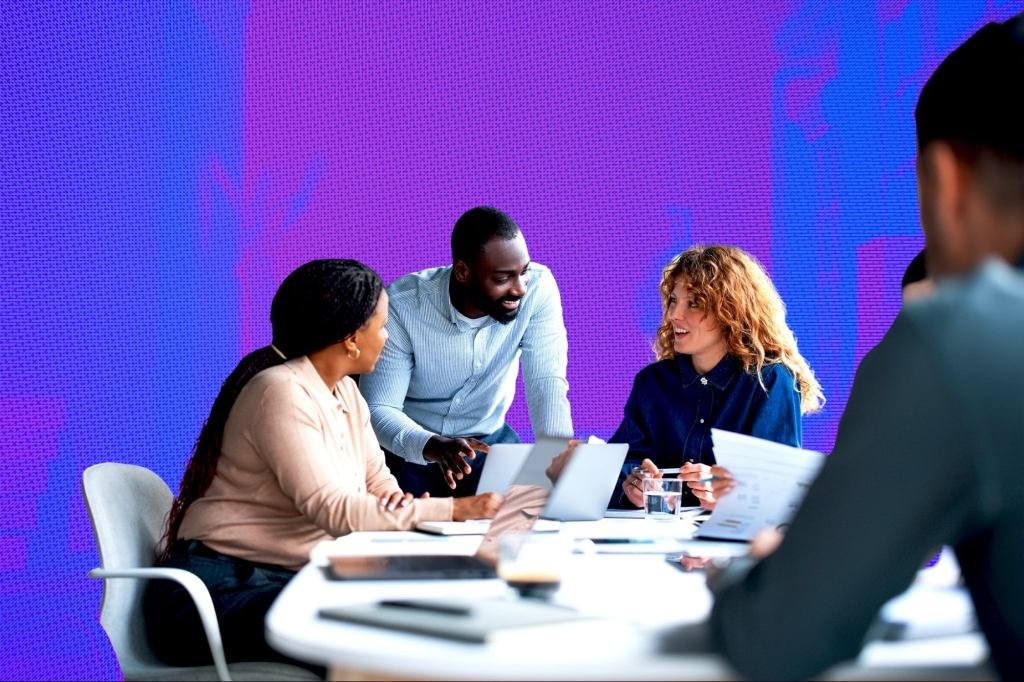 A diverse group of professionals collaborating, symbolizing adaptable skills and cross-domain knowledge sharing in a modern business environment.