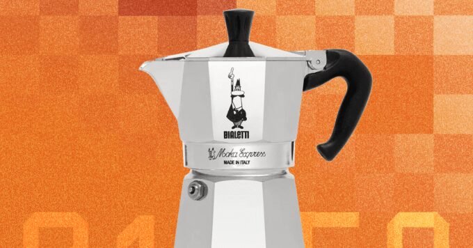 Moka Pot Magic: The Enduring Simplicity of Stovetop Coffee Perfection 9 A classic silver Bialetti Moka Express coffee maker on a stovetop, brewing coffee.