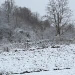 Heavy snow covering a mountainous road in Morocco under a cloudy sky