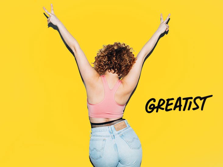 A person smiling while engaging in a healthy activity, symbolizing successful weight loss and improved well-being with the Noom Med GLP-1Rx Program.