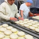 The Unseen Backbone: How One Bakery Fuels NYC's Iconic Bodegas 4 A bustling New York City bodega counter with fresh bread and baked goods, hinting at a local bakery's supply.