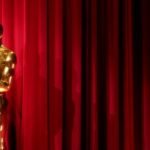 An Oscar statuette with a backdrop of digital prediction market graphs, symbolizing data-driven award forecasts.