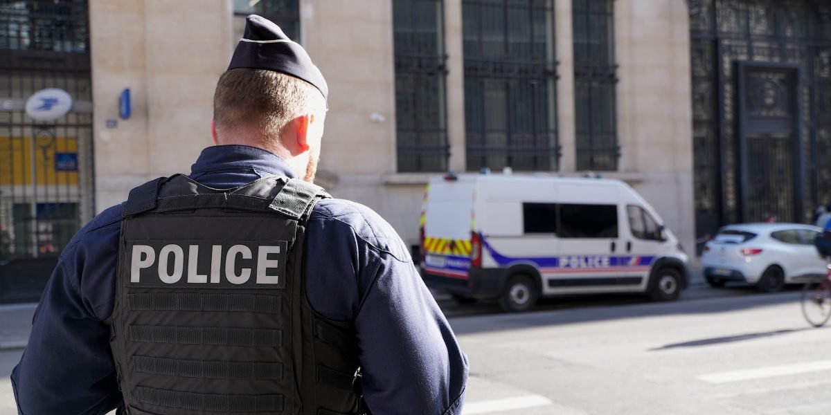 French police car outside a Bank of America building in Paris, symbolizing a thwarted bomb attack.
