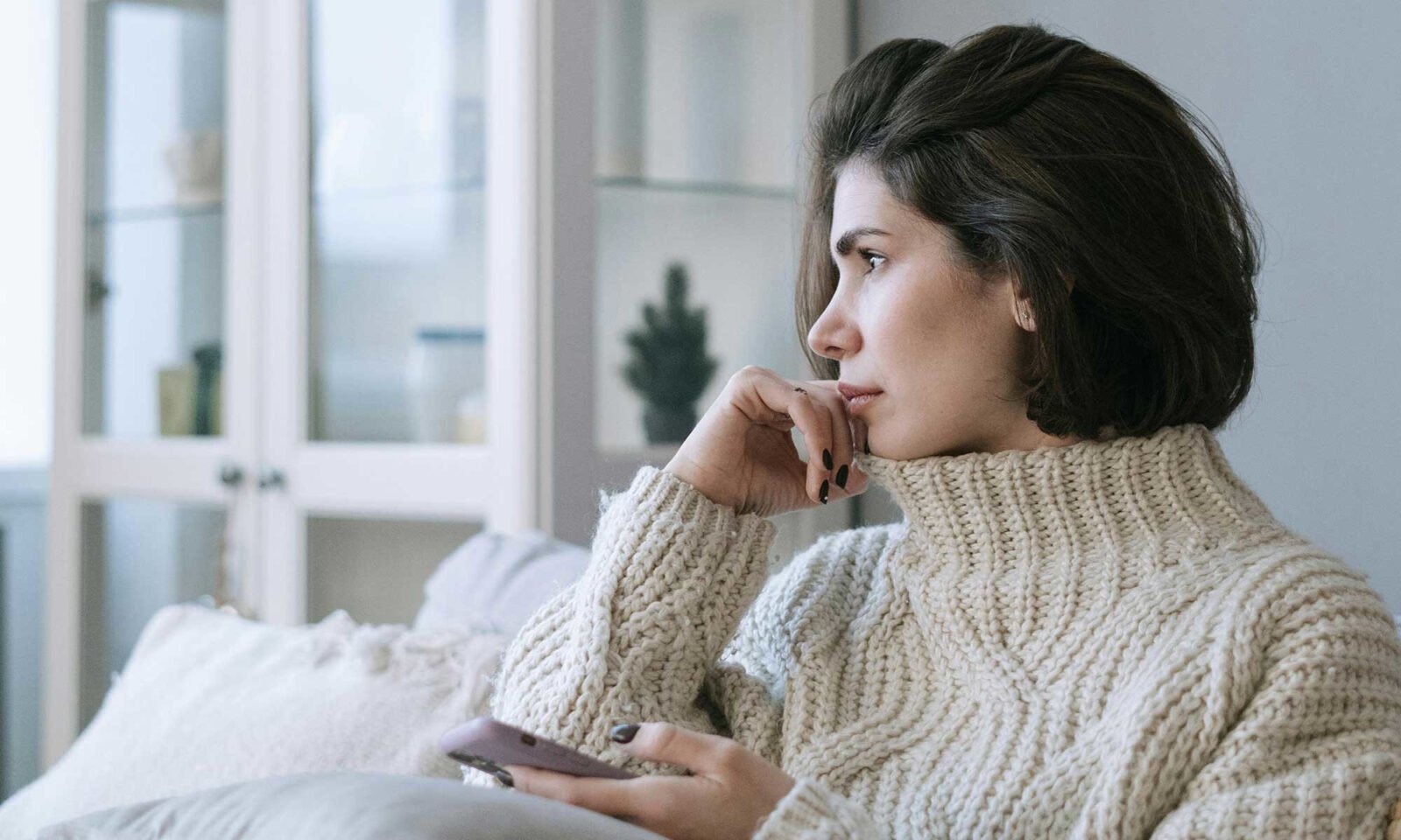 Reclaim Your Focus: Navigating Perimenopausal Brain Fog with Nutritional Support 3 A thoughtful woman, representing the mental challenges and quest for clarity during perimenopause.