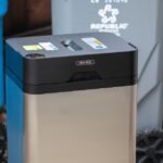 The Clear Drop Soft Plastic Compactor machine with a finished plastic brick on top.