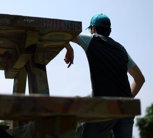 Teenage Stakes: The Unregulated Rise of Gambling in Prediction Markets 11 A young person looking intently at a screen, possibly a smartphone or computer, with abstract financial graphs or betting interfaces in the background, symbolizing online prediction markets and youth engagement.