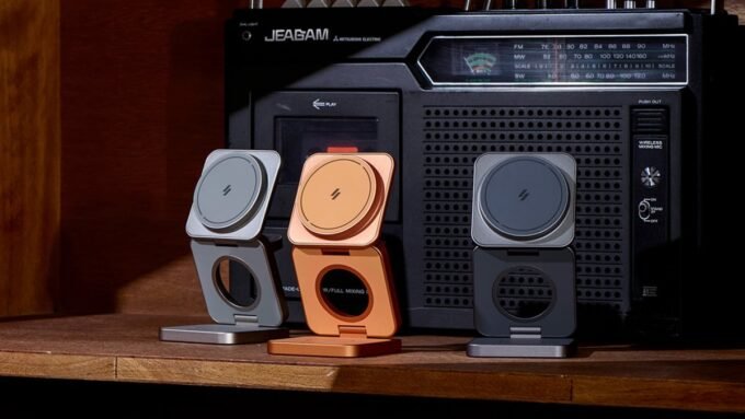 A compact, foldable 3-in-1 wireless charger powering an iPhone, Apple Watch, and AirPods simultaneously on a clean surface.