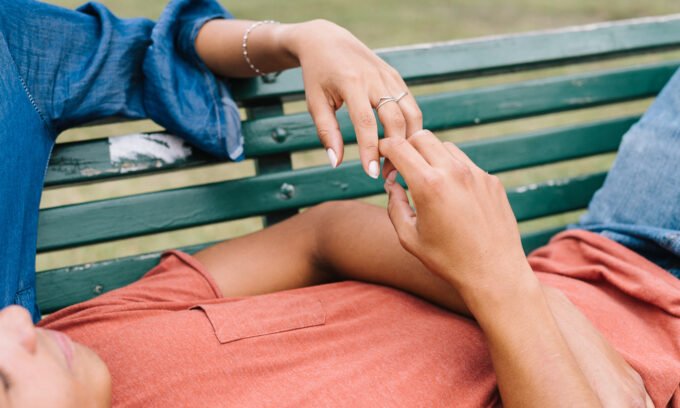A couple holding hands, symbolizing connection and support during or after a disagreement.