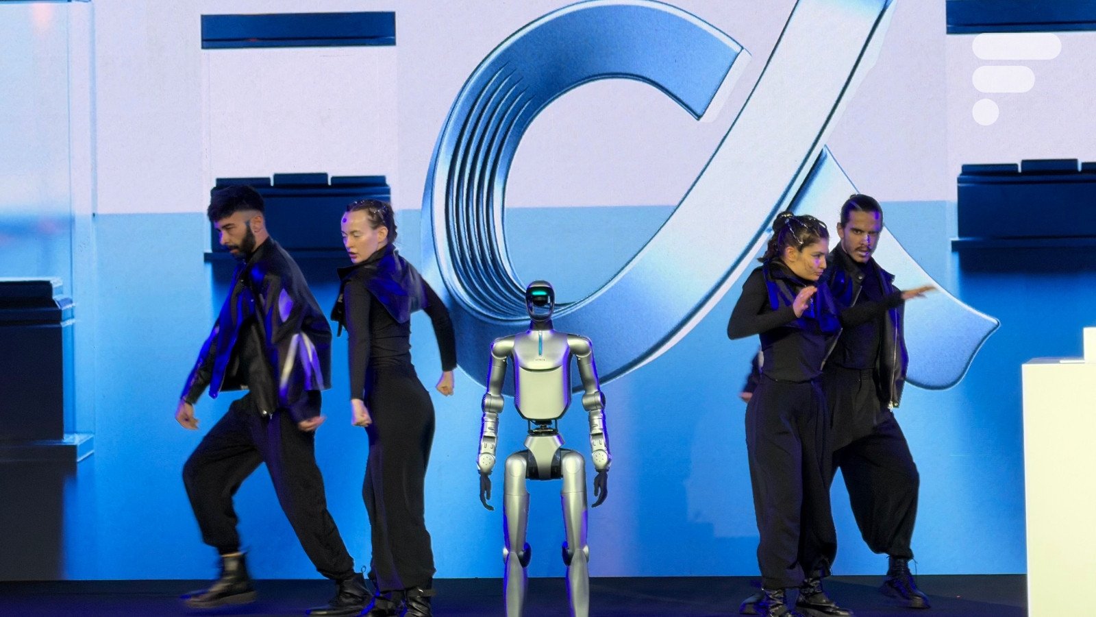 Le robot humanoïde de Honor effectuant un salto arrière sur scène lors du MWC 2026, avec le PDG James Li à ses côtés.