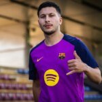 Roony Bardghji in an FC Barcelona kit, looking determined on the pitch.