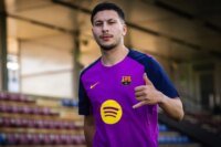 Roony Bardghji in an FC Barcelona kit, looking determined on the pitch.