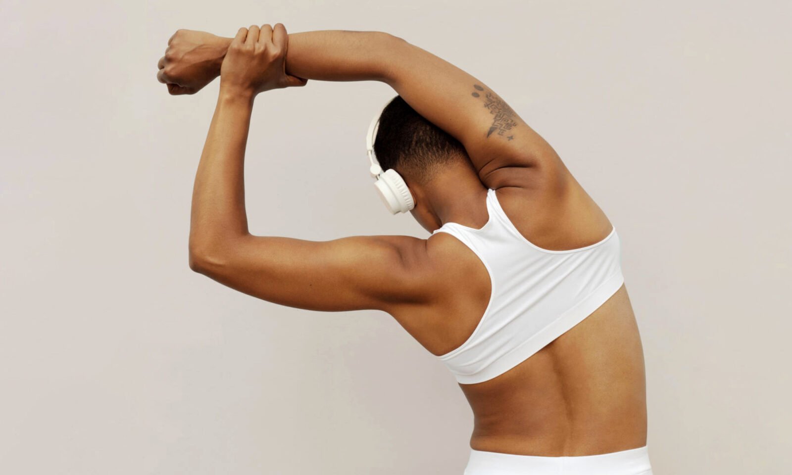 An older woman lifting weights, symbolizing strength and muscle preservation and healthy aging.