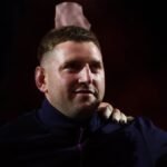 Rugby players from Scotland and France in intense action during a Six Nations match at Murrayfield Stadium.
