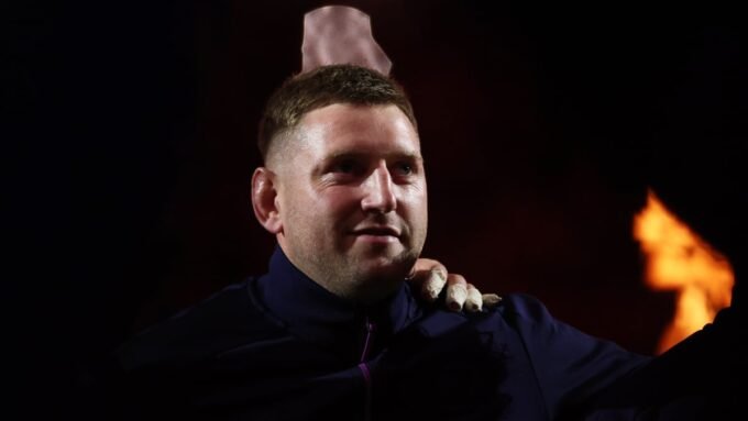Rugby players from Scotland and France in intense action during a Six Nations match at Murrayfield Stadium.