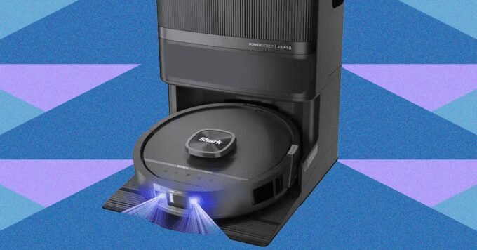 The Future of Floor Care? Unveiling the Shark PowerDetect UV Reveal Robot Vacuum 9 Shark PowerDetect UV Reveal robot vacuum with blue UV light activated, cleaning a hard floor.