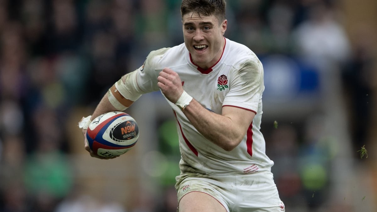 Italy and England rugby players battle for possession during a Six Nations match