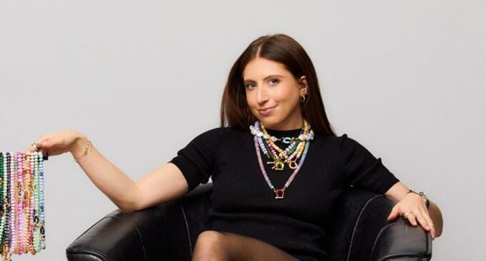 Danielle Meyer, founder of Spicy Dan, showcasing her unique, bold beaded jewelry.
