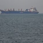 Commercial ships anchored near the UAE coast due to navigation disruptions in the Strait of Hormuz, highlighting the global energy crisis.