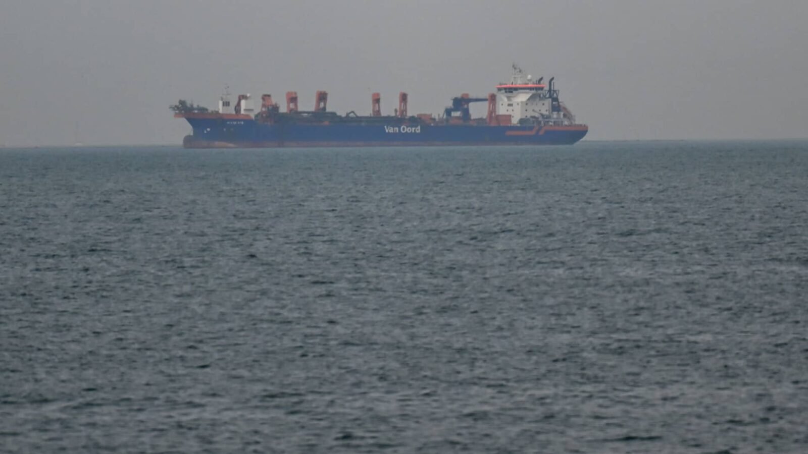 Hormuz Under Threat: Asia's Vulnerability in a Global Energy Crisis 3 Commercial ships anchored near the UAE coast due to navigation disruptions in the Strait of Hormuz, highlighting the global energy crisis.