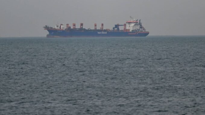 Hormuz Under Threat: Asia's Vulnerability in a Global Energy Crisis 9 Commercial ships anchored near the UAE coast due to navigation disruptions in the Strait of Hormuz, highlighting the global energy crisis.
