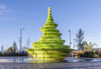The Fountain by Neon, a multi-tiered, lime-green public water feature cascading water in Brent Cross Town, London.