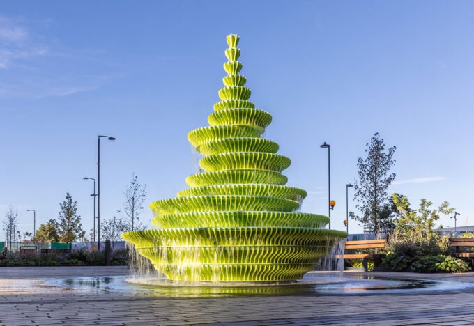 The Fountain by Neon, a multi-tiered, lime-green public water feature cascading water in Brent Cross Town, London.