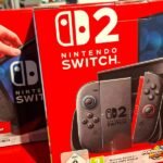 A stack of US dollar bills with a gavel and a small American flag, symbolizing legal and financial disputes over trade tariffs.