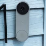 The Ultimate Guide to Video Doorbells (2026): Smart Security for Every Home 4 A sleek, modern video doorbell camera mounted on a front door, showing a wide-angle view of a package delivery.