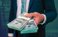 A panoramic view of the Wall Street financial district in New York City with skyscrapers and a bustling street scene, symbolizing record-breaking bonuses.