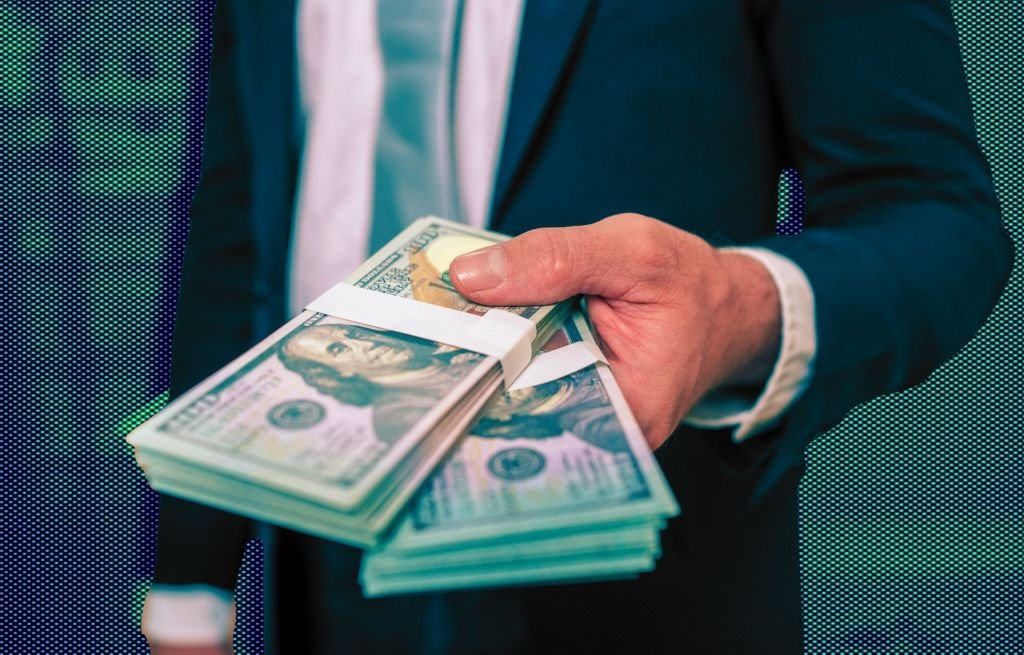 A panoramic view of the Wall Street financial district in New York City with skyscrapers and a bustling street scene, symbolizing record-breaking bonuses.
