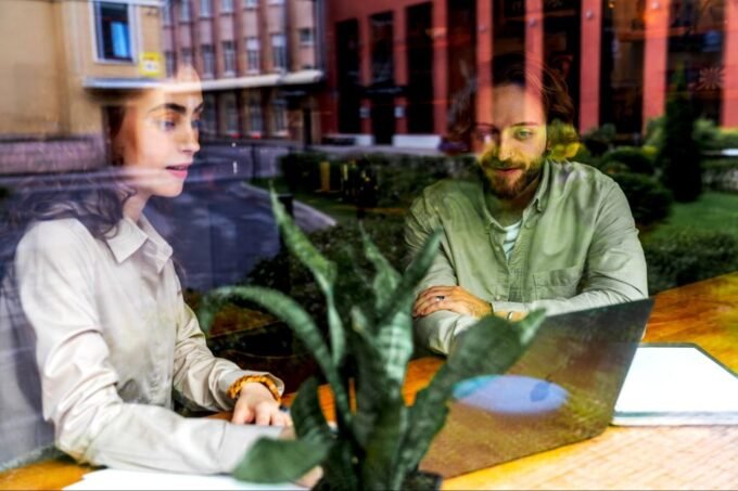 A person building a business with blocks, symbolizing foundational growth and strategic development for a solo agency.